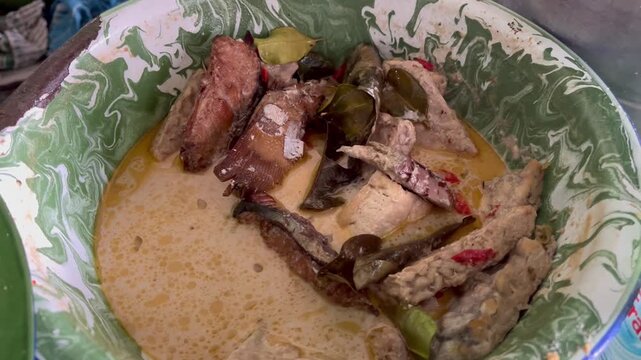 Authentic Indonesian traditional dish with rich spices and herbs served on vintage plate