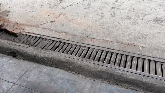 Street Drainage Grate on Concrete Road Gutter for Urban Infrastructure