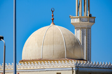 Mosque dome and minaret tower against clear blue sky architectural detail © Buğra Kaan Ersoy