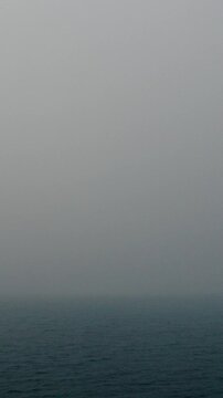 Calm Sea Disappearing into Thick Coastal Fog