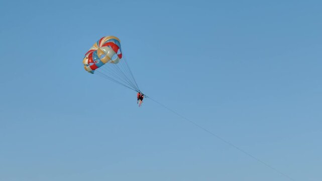 Tourist Parasailing Above the Beach with drone Photography Add-on Package