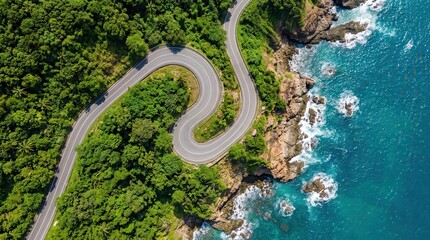Obraz premium High angle shot of a scenic asphalt highway curving along a rocky ocean shore.