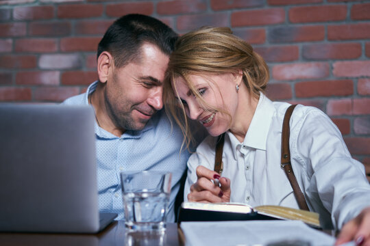Happy business people working together on laptop in a restaurant