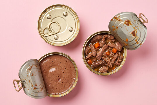 Variety of Opened Pet Food Cans on Pink Background for Commercial Use