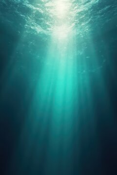 Underwater scene with sunlight streaming through rippling surface, blending turquoise and deep blue tones into darker depths, evoking serene ethereal ocean atmosphere.