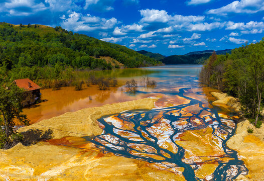 Spectacular, extremely toxic colors on the surface of the Geamana tailings pond appear due to chemical oxidation-reduction processes of minerals and heavy metals spilled from the copper mining