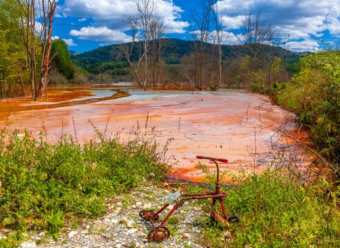 Landscape with artificial tailings pond at Geamana Flooded Village in the Apuseni Mountains of Alba County, Romania, dumping ground for toxic waste from the nearby Rosia Poieni copper mine