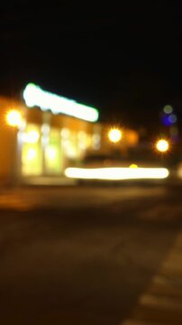 Vertical city timelapse with traffic and illuminated storefront