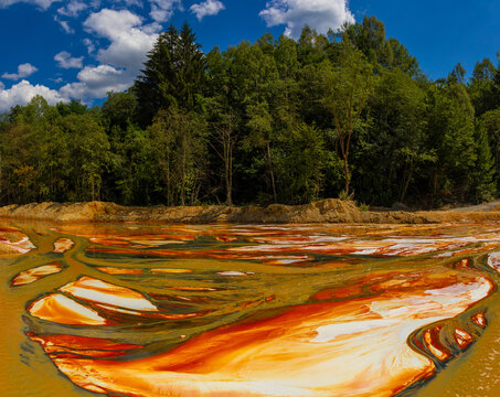 Landscape with artificial tailings pond at Geamana Flooded Village in the Apuseni Mountains of Alba County, Romania, dumping ground for toxic waste from the nearby Rosia Poieni copper mine