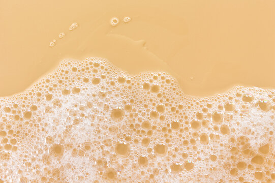 Foam sheet with holes below a light orange field