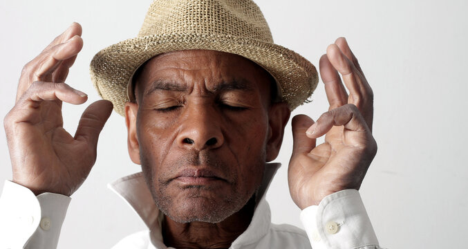 A serene portrait of a man praying with hands together in deep prayer that perfectly captures themes of faith, hope, mindfulness, and inner peace stock image stock photo