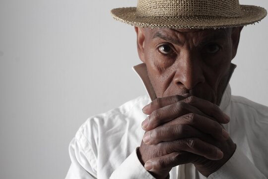 A serene portrait of a man praying with hands together in deep prayer that perfectly captures themes of faith, hope, mindfulness, and inner peace stock image stock photo