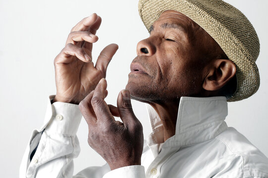 A serene portrait of a man praying with hands together in deep prayer that perfectly captures themes of faith, hope, mindfulness, and inner peace stock image stock photo