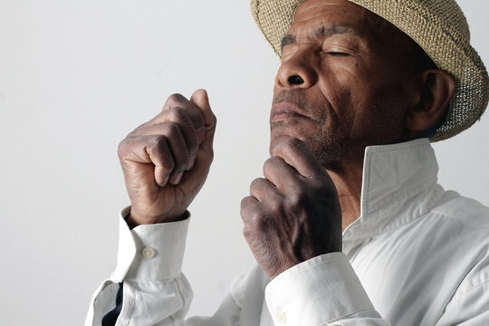A serene portrait of a man praying with hands together in deep prayer that perfectly captures themes of faith, hope, mindfulness, and inner peace stock image stock photo