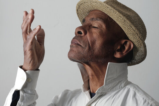 A serene portrait of a man praying with hands together in deep prayer that perfectly captures themes of faith, hope, mindfulness, and inner peace stock image stock photo
