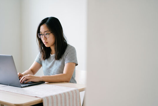 Woman professional holding clipboard working in bright office environment