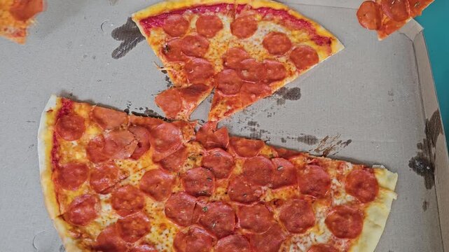 Making a pepperoni pizza by cutting it into slices