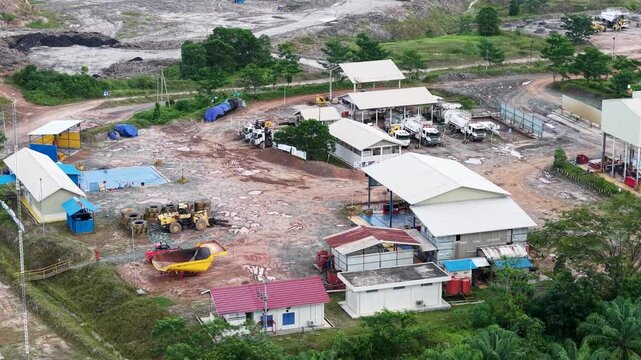 industrial mining support and maintenance camp featuring auxiliary structures, storage yards, and heavy equipment infrastructure