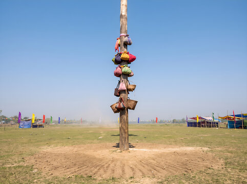 Tall Decorated Traditional Penjor Bamboo Pole Standing Against Blue Sky at Festival
