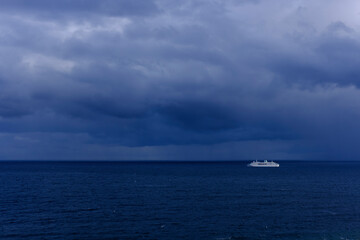 Fototapeta premium Cruise Ship Sailing Through Cloudy Seas off Donostia-San Sebastian on the Cantabrian Coast of Spain