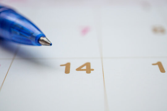 Blue pen on calendar page background business planning appointment meeting concept