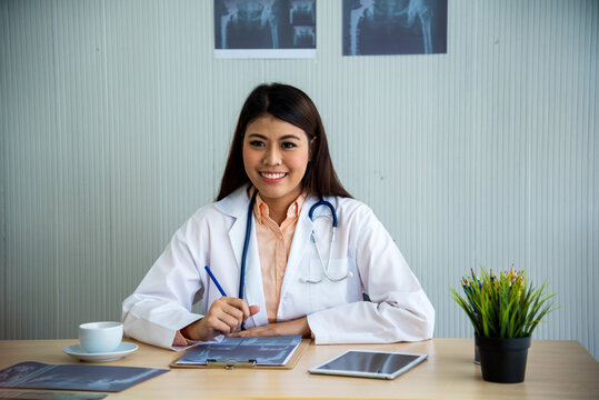 Portrait woman Nurse doctor in white lab coat, stethoscope. Portrait asian female doctor looking at camera medical Lab Clinic. Young Women smile doctor in lab coat call Conference Laboratory meeting