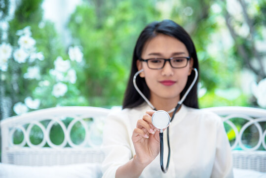 Portrait woman Nurse doctor in white lab coat, stethoscope. Portrait asian female doctor looking at camera medical Lab Clinic. Young Women smile doctor in lab coat call Conference Laboratory meeting