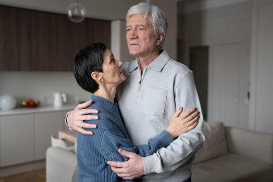 Worried distressed older couple hugging soothe one another with care. Relationship strength through adversity, familial love affection, aging together, financial difficulties faced by pensioners. 
