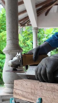 Close-up industrial footage of an angle grinder cutting steel and producing bright sparks during metal fabrication work.
