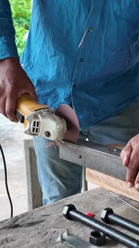 Close-up industrial footage of an angle grinder cutting steel and producing bright sparks during metal fabrication work.
