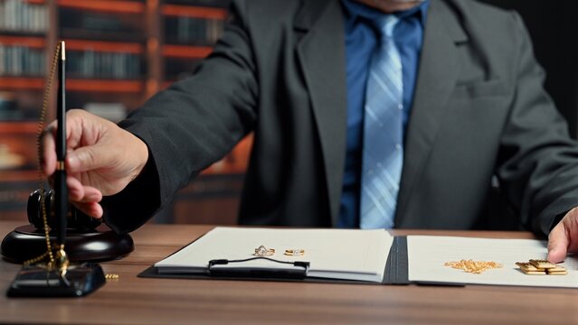 Legal counselor oversees legal settlement involving property division, executing legal papers regarding marital settlement inside complex divorce court.