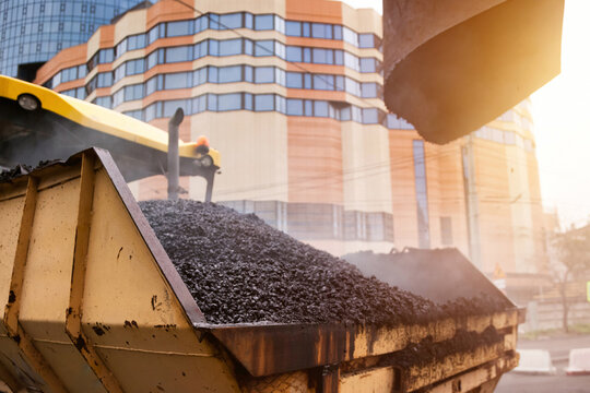 City Street Renovation Featuring Asphalt Concrete Paving and Heavy Machinery at Work