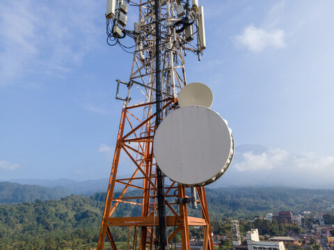 Aerial View of Steel Structures, Radio Masts and Antennas on a Telecommunication Tower in a Rural Countryside with Slamet Mountain in the Distance, Indonesia. 
