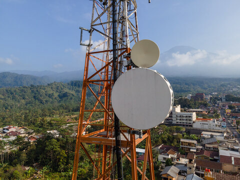 Aerial View of Steel Structures, Radio Masts and Antennas on a Telecommunication Tower in a Rural Countryside with Slamet Mountain in the Distance, Indonesia. 