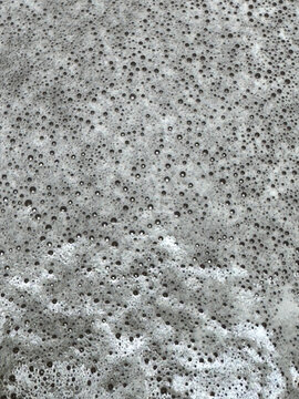 Of gray soapy water foam with numerous bubbles