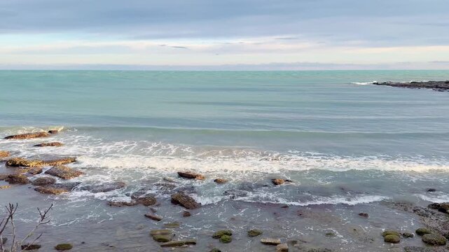 Waves Crashing on Rocky Coastline at Sunset 