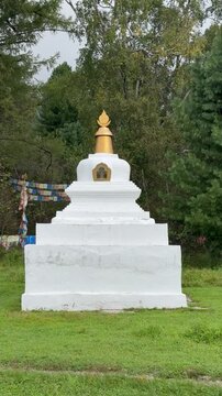 Vertical video of Buddhist stupa or suburgan near the datsan Bodhidharma in the village of Arshan in the foothill valley of the Tunka Nature Park. Siberia, Baikal Region, Buryatia, Tunka Valley