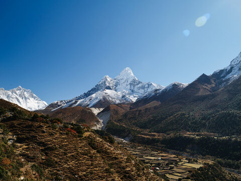 Stunning view of snow-capped peaks in the Himalayas, Nepal, Everest Region, featuring the iconic mountain Ama Dablam under a clear blue sky