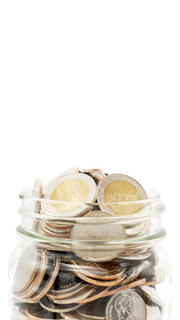 Glass jar full of Thai baht coins. Business and finance concept. Vertical Photography.