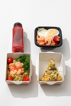 Healthy low carb diet food ration with shrimp caesar salad zoodles quiche and berry smoothie on white background