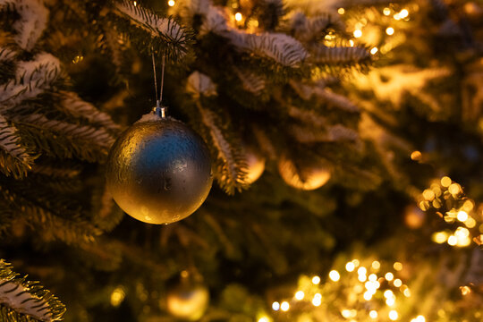Decorated Christmas tree with ornaments and lights in a winter setting