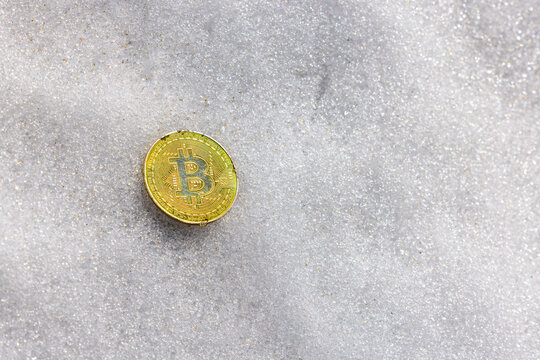 Gold Coin with B Symbol on Textured White Surface
