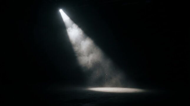 A solitary beam of light pierces the darkness, illuminating a circular patch on a textured surface, creating a dramatic and atmospheric scene