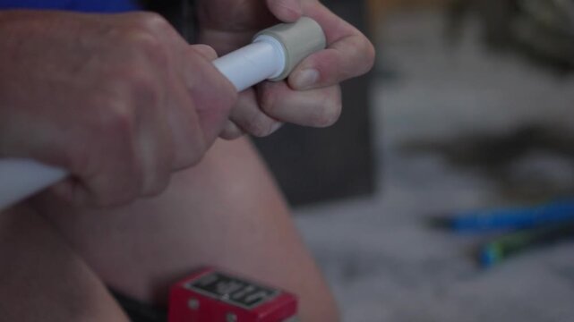 Highly engaging commercial ready closeup video of a worker welding polypropylene pipes using a professional socket fusion heating tool.