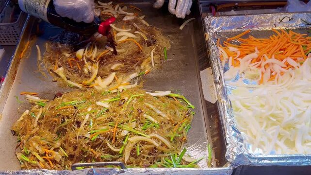 Stirring Noodles on Hot Griddle with Soy Sauce &ndash; Korean Street Cooking