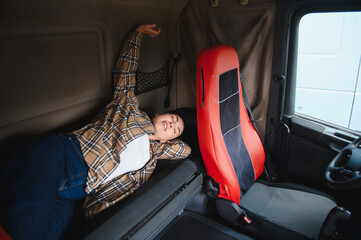 Female truck driver resting in vehicle sleeper cabin