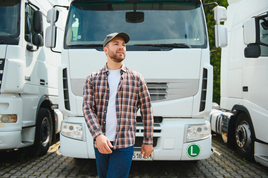 Truck driver standing confident near white semi truck