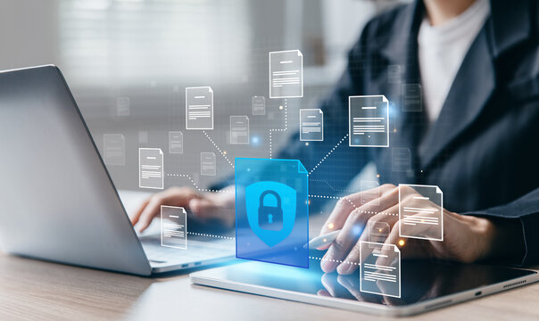 Businesswoman working with documents while security shield protects connected files.