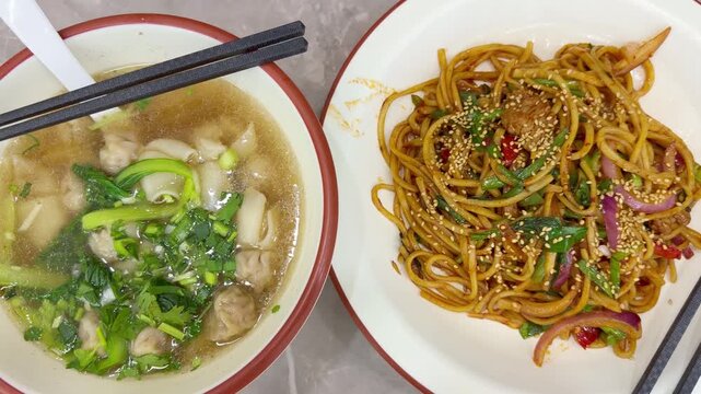 Chinese Restaurant Table with Noodles on Plate and Wonton Soup in Bowl &ndash; Traditional Dumplings and Noodle Dish
