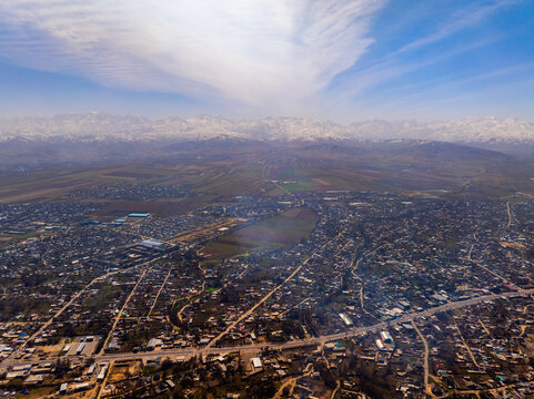 Aerial View of Town with Snow-Capped Mountains in Kyrgyzstan